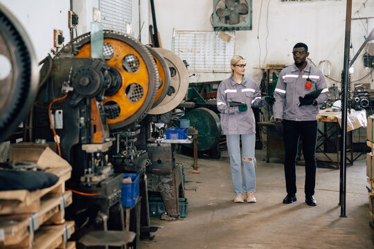 professional engineer officer team inspecting safety audit old machine in heavy industry factory