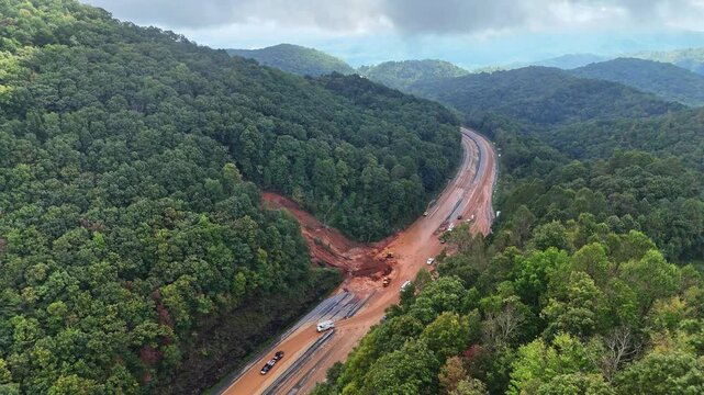 Traffic drives through mudslide during Hurricane Helene in Swannanoa, NC.