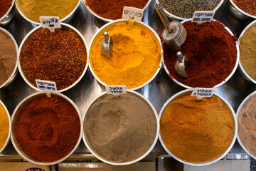 Overhead, high angle view of a variety of ground spices in a spice stall in Jerusalem's Mahane Yehuda Market