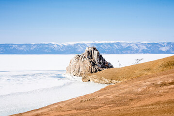 Landscape ice blue deep lake winter clouds Baikal Siberia Russia rock Shamanka