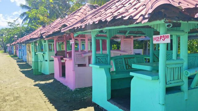 Golden sandy beaches and charming beach huts nestled among lush tropical palm trees in Bacuag, Surigao Del Norte. Perfect for summer vacations, weekend getaways, and tropical adventures under clear bl