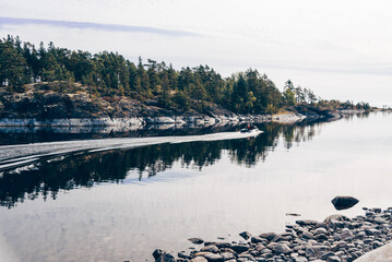 Landscape blue deep lake light sun, clouds sky mountains Ladoga skerries Karelia