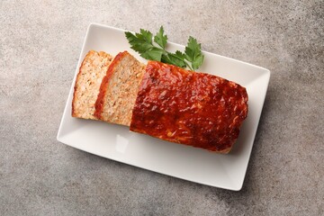 Delicious baked turkey meatloaf with parsley on grey table, top view