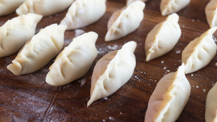 Chinese dumplings on a wooden table. Gyoza on a wooden surface close-up