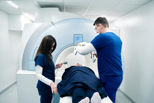 Medical scientific hospital laboratory meeting: Diverse team of neurologists, neuroscientists, neurosurgeons taking MRI, CT scan of patient, Talk About Treatment Method, New Drugs Cure