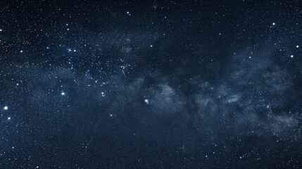 Fototapeta premium A dark, starry sky with a band of the Milky Way galaxy.