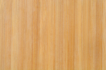 Naklejka premium A light brown bamboo cutting board with visible grain and fibers