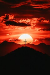 Obraz premium Cross on hilltop surrounded by glowing golden flowers, vibrant sunset, city view below, and distant mountains, symbolizing serenity