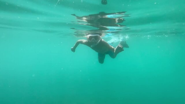 Underwater footage of children, playing, swimming, diving in open sea, preschooler and teenager boys