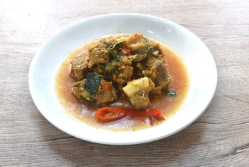 spicy fried pork soft bone with curry and basil on plate 