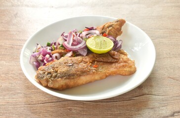 fried dry pickled fish taste sour and salty topping chop shallot and chili with slice lemon salad on plate 