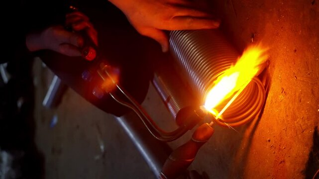 Slow-motion video close-up of metal cutting by autogenous welding in a factory. Industrial concept of the work of manufacturing a robot with metal. High quality 4k footage