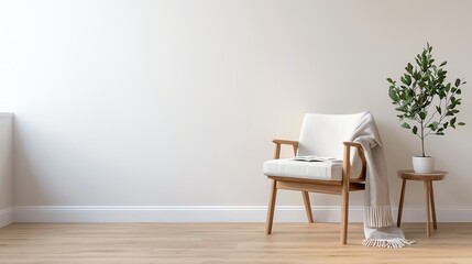 Minimalist living room with a cozy armchair, small table, and potted plant, creating a serene and inviting home interior atmosphere.
