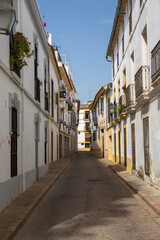 Empty street between houses in Cordoba, Spain.