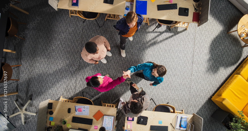 Aufkleber top down view of diverse team giving high five in an office, symbolizing unity and teamwork. profess