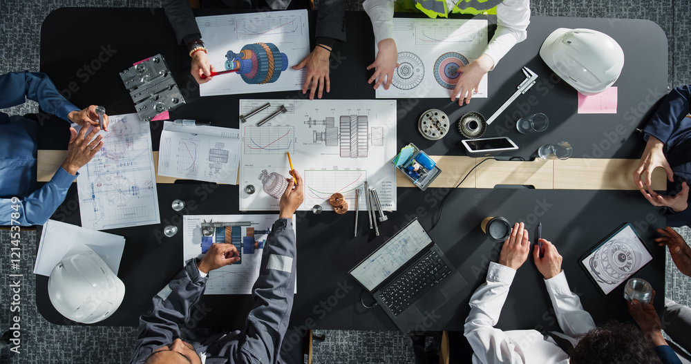 Poster Top Down View of Diverse Team of Business Professionals and Engineers Working Together on Architectural Plans in a Corporate Office. Focused Colleagues Using Laptop, Tablet, Blueprints And Documents