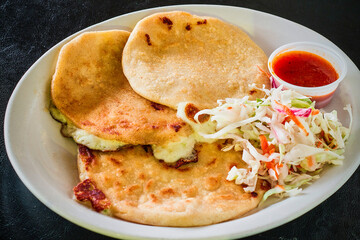 cheese pupusa with a sweet chili dipping sauce