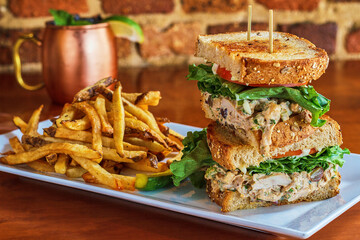 chicken salad sandwich with a side of fries