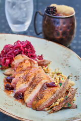 pan seared duck breast, sliced and served with braised red cabbage