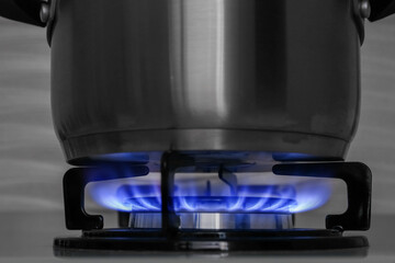 Pot on modern gas cooktop in kitchen, closeup