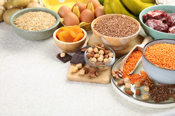 Different products rich in iron on light table, space for text. Anemia diet plan