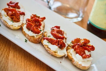sundried tomato bruschetta with whipped ricotta on toasted baguette