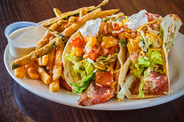ahi tuna fish tacos with shredded lettuce, salsa, and sour cream
