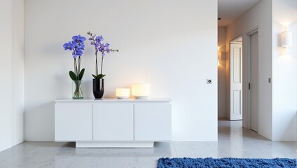 Elegant white sideboard adorned with two contrasting black vases; one holding a verdant glass sculpture and another showcasing vibrant purple orchids, exuding refined elegance in an intimate indoor se