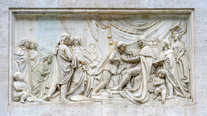 Ancient stone bas relief sculpture part of the Monument to Felipe IV in the Plaza del Palacio Real, Madrid, Spain