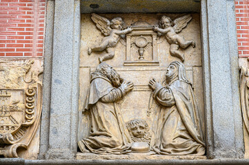 Ancient stone bas relief sculpture in the facade of the Monastery of Corpus Christi las Carboneras, Madrid, Spain