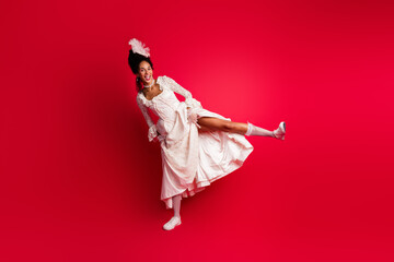 Photo of fun excited lady dancing in sock sneakers dress enjoy different era diversity isolated red color background