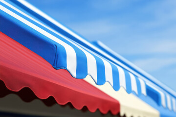 Fototapeta premium A blue and red striped awning with white stripes