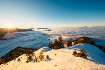 Winter hiking to Sina in Low Tatras National park near jasna is full of beautiful views. Sunset in Slovakia mountains with Chopok peak.
