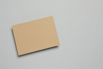 Craft paper card on gray background