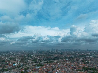 Aerial view of a city under a dramatic, cloudy sky. Perfect for backgrounds or illustrating weather.