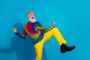 Full size photo of funky old man winning dancing dressed colorful disco outfit isolated on blue color background