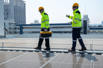 Young engineer in uniform sits on a solar farm, clean energy