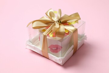 Colorful bento cake packed in a box with a bow on color background