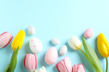 Easter decor concept. Top view photo of colorful eggs with tulip flowers on color background