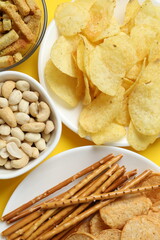 Various unhealthy snacks on a colored background
