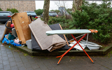 Bulky waste with ironing board on the street for recycling in the city