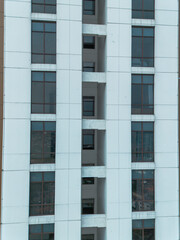High-angle view of a modern apartment building's exterior, showcasing its architectural design and repeating window patterns.