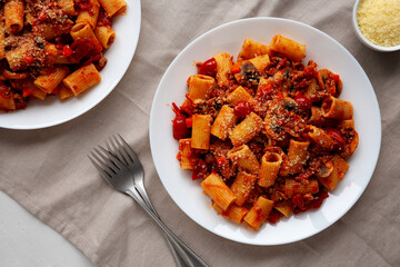 Homemade Italian Sausage and Mushroom Ragu Rigatoni Pasta with Cheese on a Plate, top view.