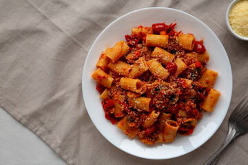 Homemade Italian Sausage and Mushroom Ragu Rigatoni Pasta with Cheese on a Plate, top view.