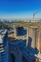 Obraz premium A large building under construction with a crane in the background, suitable for use in architecture or construction projects