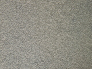 even layer of light household or construction dust macro view, fluffy layered white dust on gray surface, close-up, heavily dusty empty space with soft smoothed texture