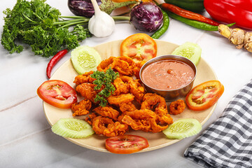 Golden fried crispy calamari with sauce