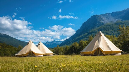 Glamping tents in mountain meadow, sunny day (1)