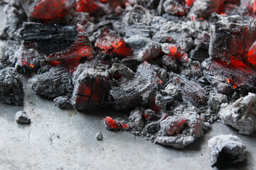 Smoldering embers of charcoal, preparation for barbeque. Charcoal background.