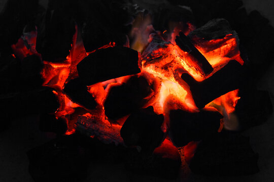 Smoldering embers of charcoal, preparation for barbeque. Charcoal background.